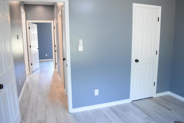 corridor featuring light hardwood / wood-style floors