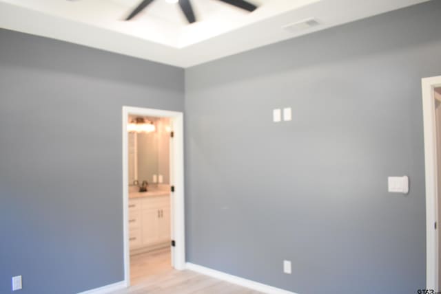 empty room featuring ceiling fan and light hardwood / wood-style flooring