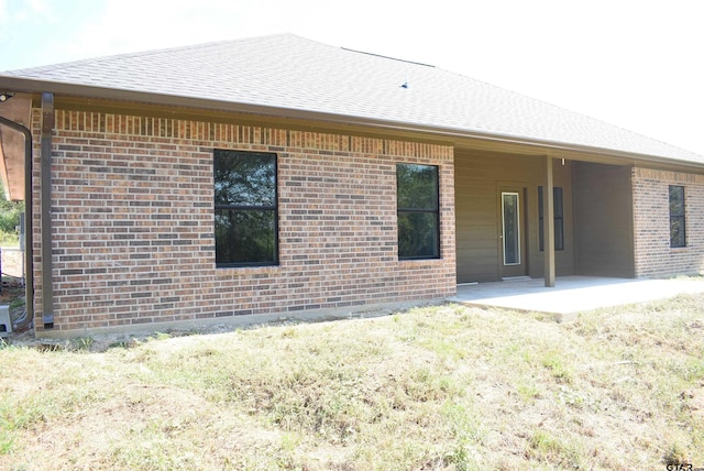 back of property with a patio