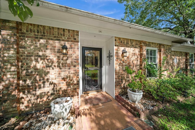 8312 Oxford Dr, Tyler, TX 75703 - doorway to property featuring brick siding and a porch