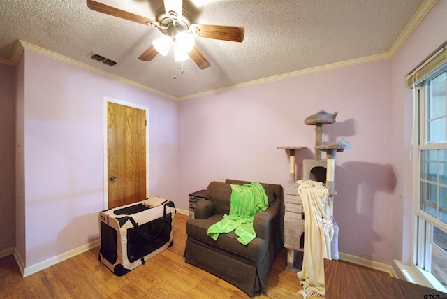8312 Oxford Dr, Tyler, TX 75703 - sitting room featuring wood finished floors, ceiling fan, a textured ceiling, and crown molding