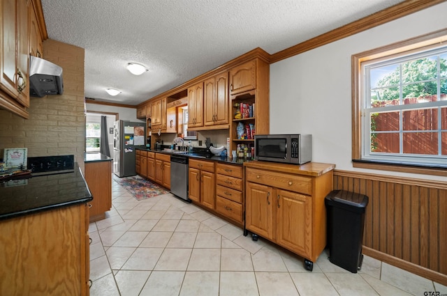 8312 Oxford Dr, Tyler, TX 75703 - kitchen with stainless steel appliances, ornamental molding, extractor fan, a textured ceiling, and dark countertops