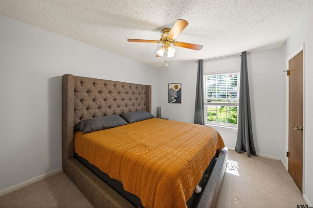 8312 Oxford Dr, Tyler, TX 75703 - bedroom with light carpet, a ceiling fan, and a textured ceiling