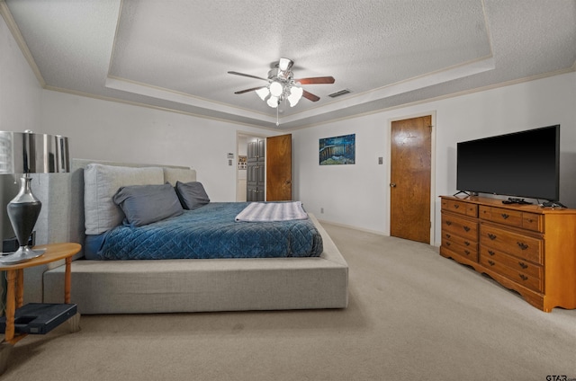 8312 Oxford Dr, Tyler, TX 75703 - bedroom featuring a tray ceiling, carpet floors, a textured ceiling, ornamental molding, and a ceiling fan
