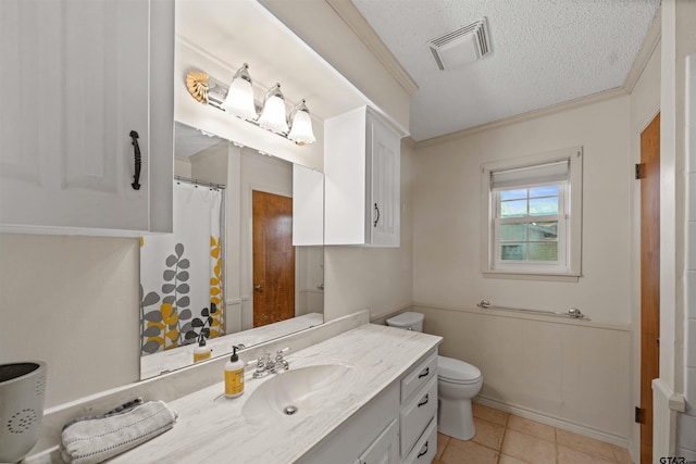 8312 Oxford Dr, Tyler, TX 75703 - bathroom with vanity, ornamental molding, a textured ceiling, wainscoting, and tile patterned floors
