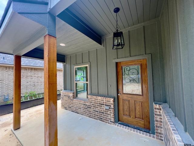2514 N Glass, Tyler, TX 75702 - view of exterior entry with board and batten siding, a porch, and brick siding