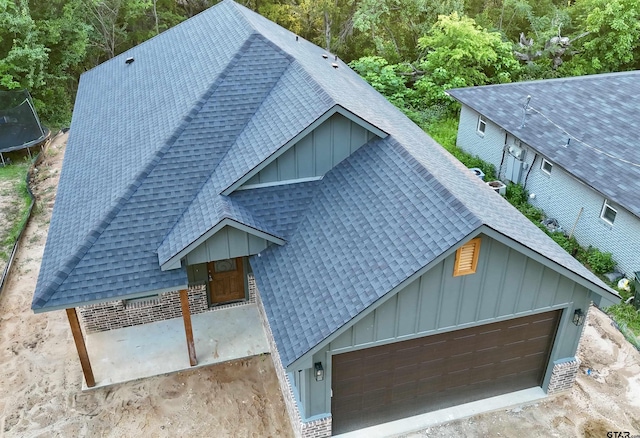 2514 N Glass, Tyler, TX 75702 - view of front of home featuring a trampoline, board and batten siding, and roof with shingles