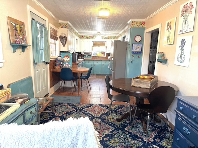 dining space with ornamental molding and tile patterned flooring