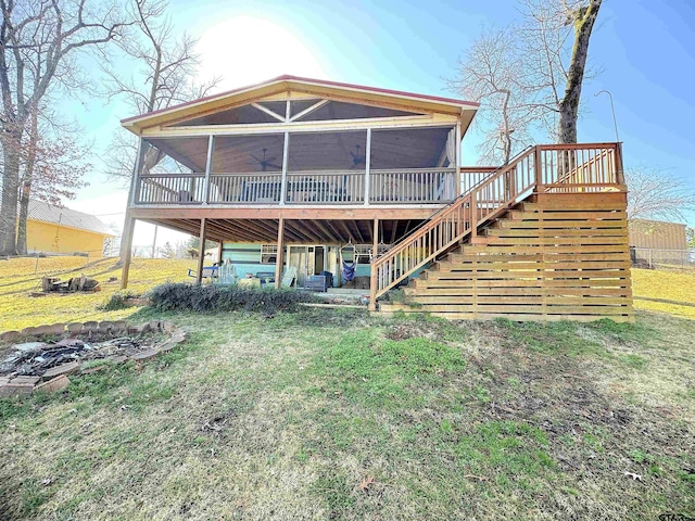 back of property featuring a sunroom and a yard