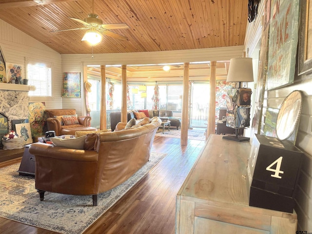 living room featuring lofted ceiling, a stone fireplace, wooden ceiling, ceiling fan, and hardwood / wood-style floors