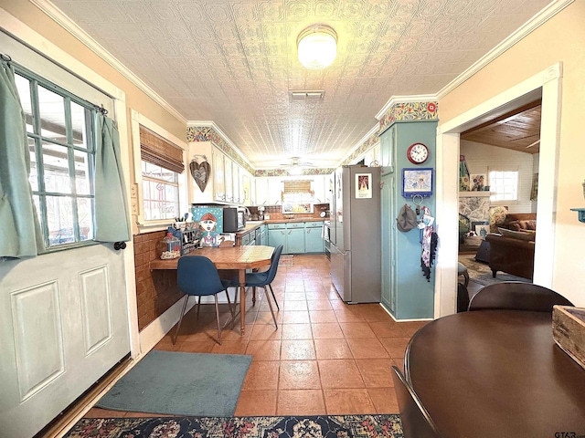 kitchen with an ornate ceiling, blue cabinets, visible vents, and ornamental molding