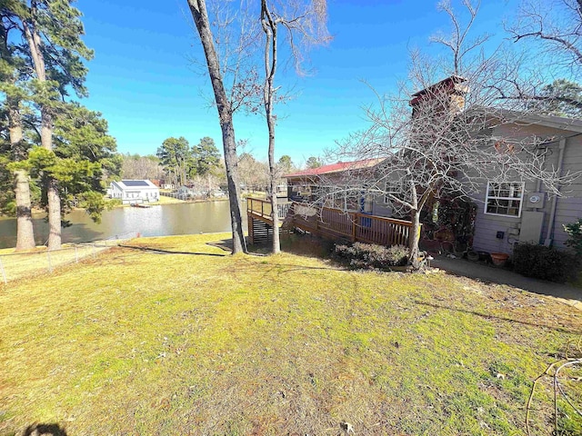 view of yard featuring a deck with water view