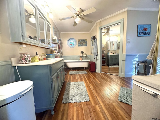 kitchen with ornamental molding, sink, dark wood-type flooring, and ceiling fan