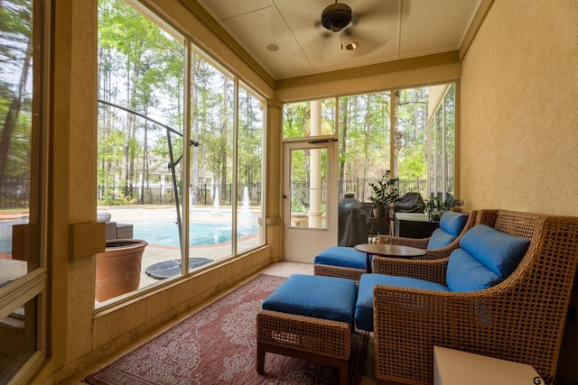 sunroom / solarium with plenty of natural light and ceiling fan