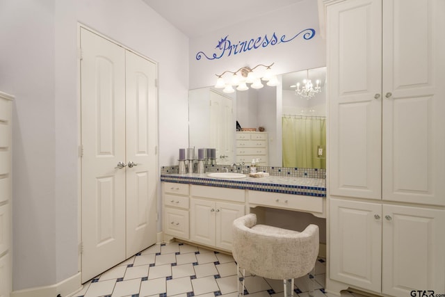 bathroom featuring vanity and a chandelier