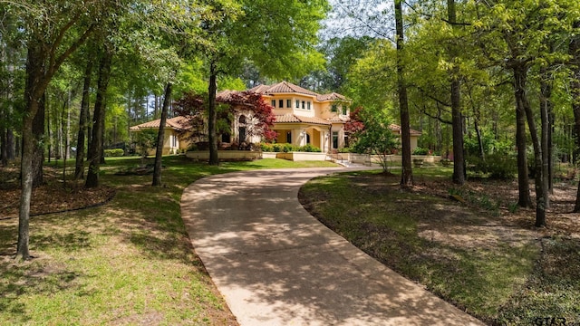 mediterranean / spanish house featuring a front lawn