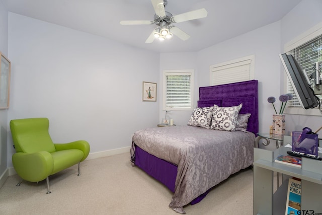 bedroom featuring ceiling fan and light carpet