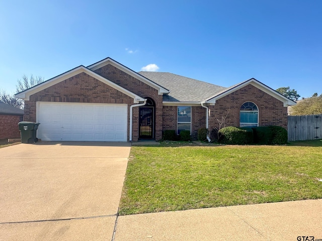 ranch-style home with a garage and a front yard