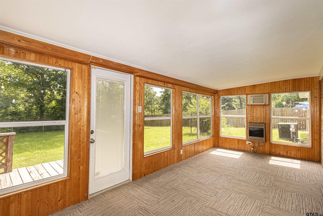 405 Brookview Ln, Palestine, TX 75803 - unfurnished sunroom with heating unit, plenty of natural light, wood walls, a wall unit AC, and carpet