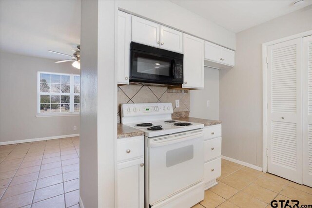 kitchen with backsplash, black microwave, light countertops, white electric range oven, and white cabinetry