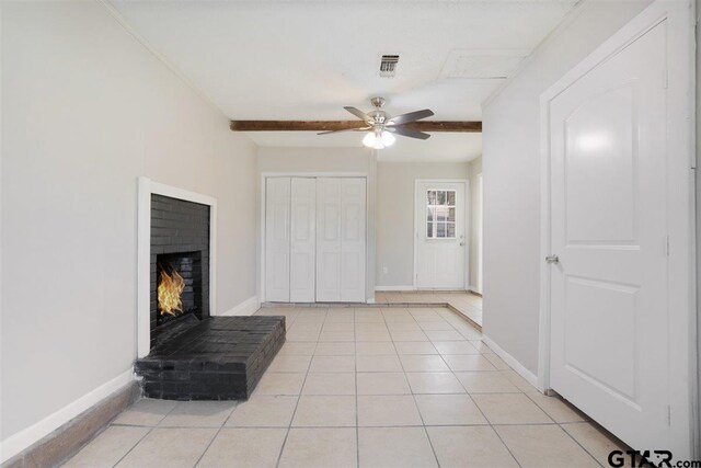unfurnished living room with visible vents, baseboards, a fireplace, light tile patterned flooring, and a ceiling fan
