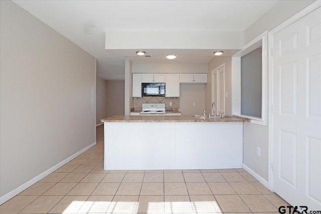 kitchen with light tile patterned floors, range with electric stovetop, a peninsula, and black microwave
