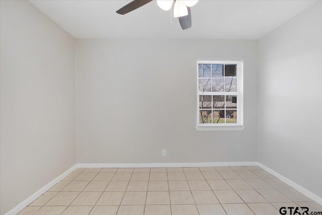spare room with baseboards and ceiling fan