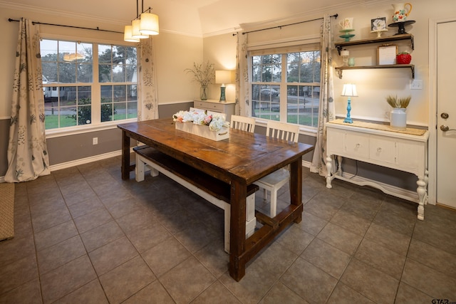 dining area with dark tile patterned floors and baseboards