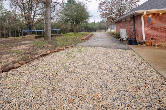 view of street with driveway and a gated entry