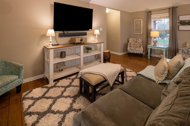 living room featuring baseboards, ornamental molding, and dark wood-style flooring