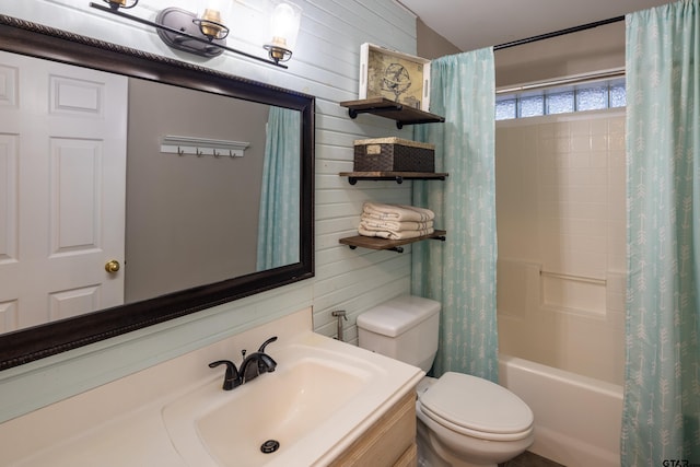 bathroom featuring vanity, wood walls, shower / bath combination with curtain, and toilet