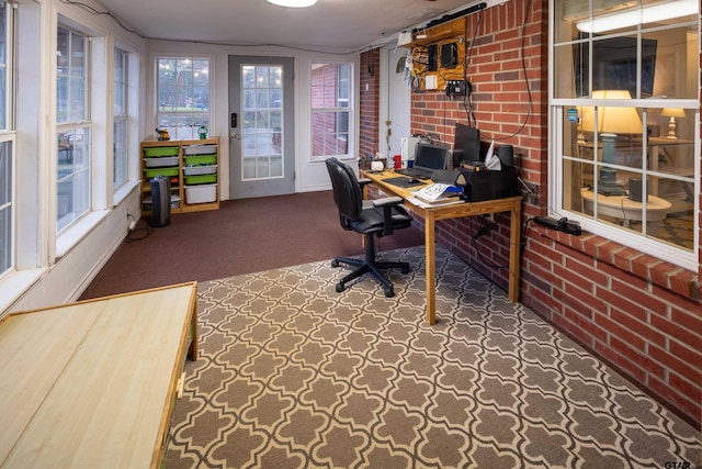 office space with brick wall