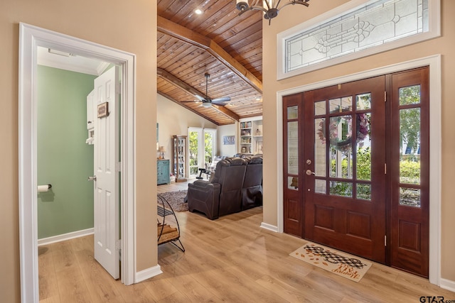 entryway with ceiling fan with notable chandelier, wood ceiling, light hardwood / wood-style flooring, and vaulted ceiling with beams