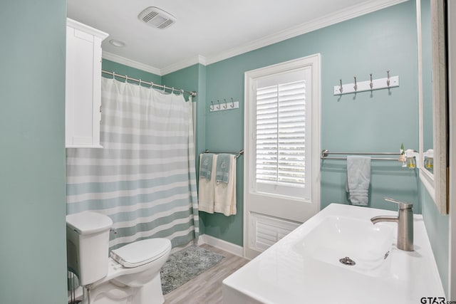 bathroom with ornamental molding, a shower with curtain, vanity, hardwood / wood-style flooring, and toilet