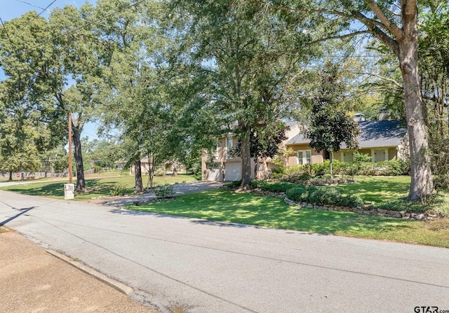 view of front of property with a garage and a front lawn