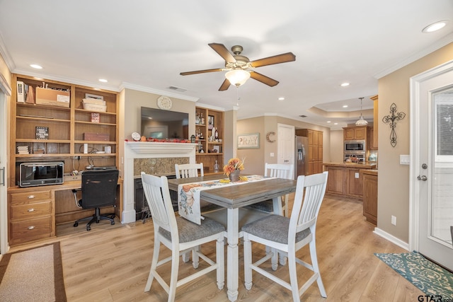 dining room with ornamental molding, light hardwood / wood-style flooring, and ceiling fan