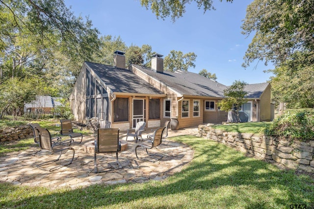 rear view of property featuring a patio area and a yard