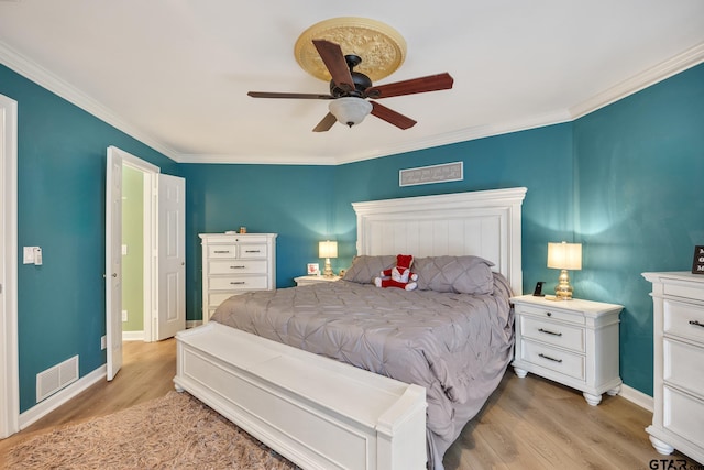 bedroom featuring ornamental molding, light hardwood / wood-style flooring, and ceiling fan