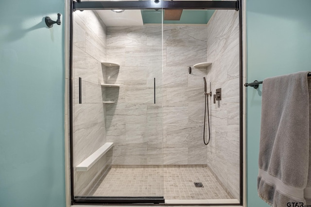 bathroom featuring a shower with shower door