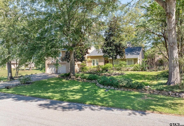 view of front facade featuring a garage and a front lawn