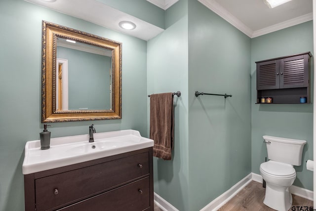 bathroom featuring hardwood / wood-style flooring, vanity, toilet, and ornamental molding