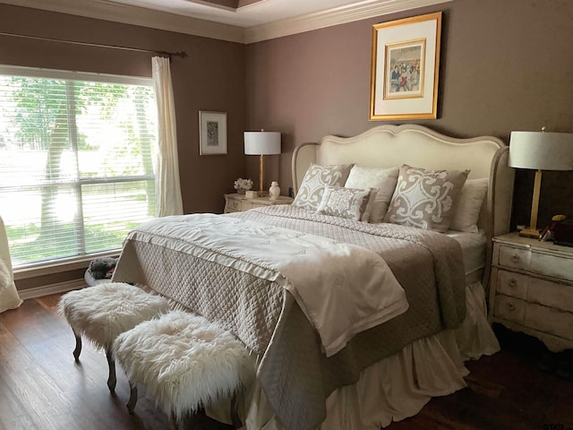 bedroom with crown molding and wood finished floors