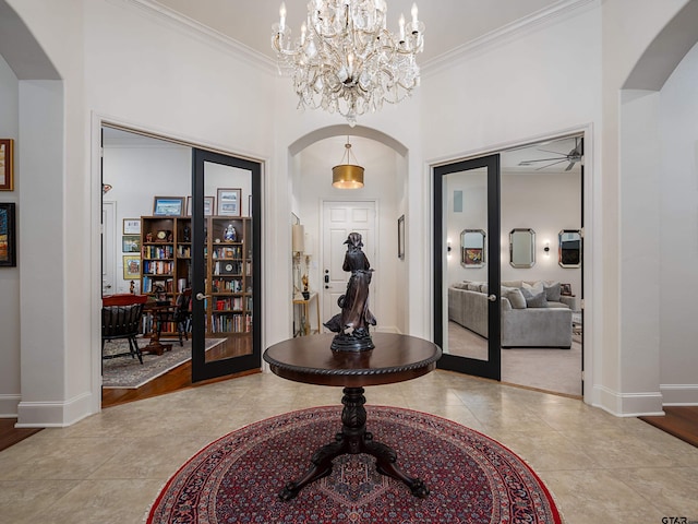 tiled entryway with french doors and crown molding