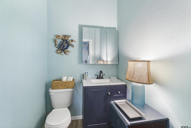 408 Morton Ave, Palacios, TX 77465 - half bath featuring toilet, vanity, and wood finished floors