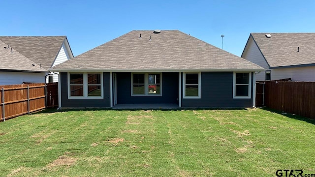 back of house featuring a yard