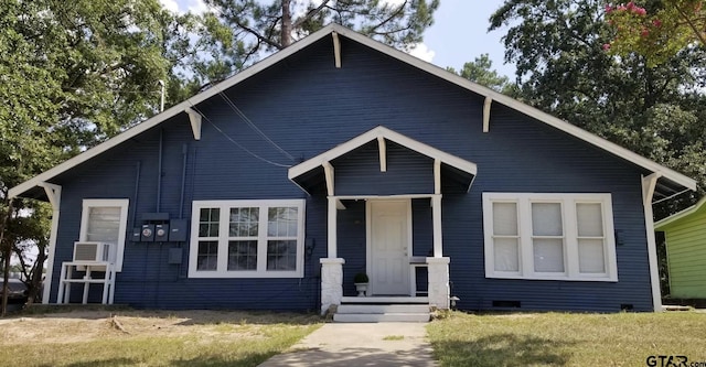 bungalow-style home featuring a front lawn