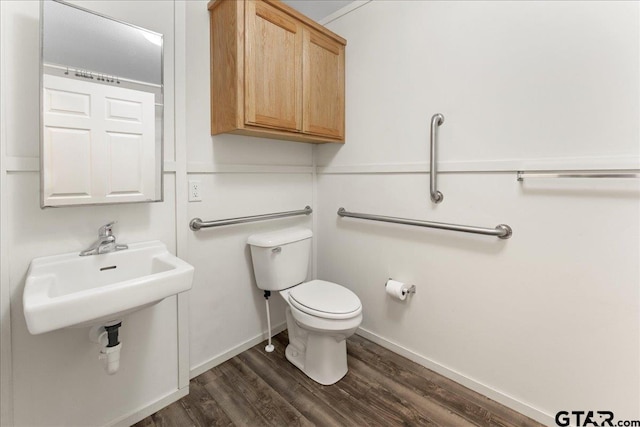 bathroom featuring toilet, wood-type flooring, and sink