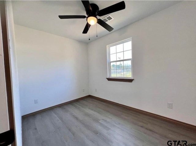 empty room featuring light wood-type flooring and ceiling fan