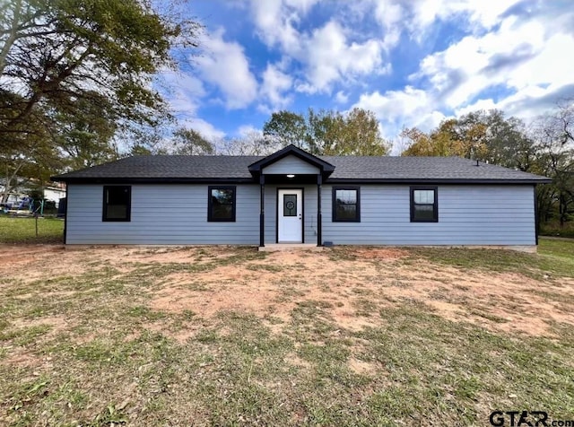 ranch-style home with a front lawn