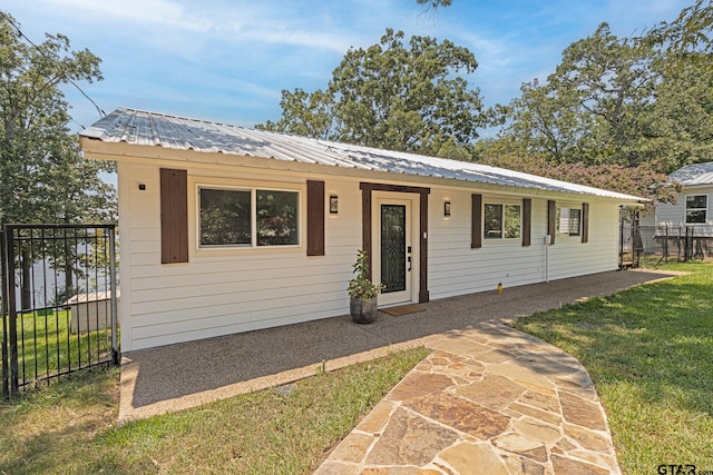 single story home with a front lawn and a patio